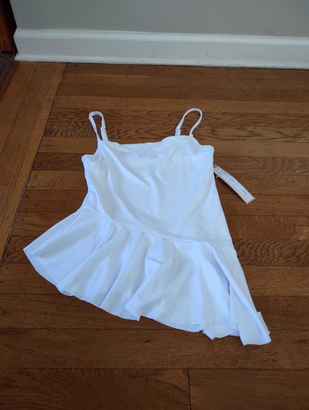 almost famous NWT white cami with asymmetrical ruffle skirt fits like small